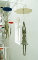 Cement People dangling from umbrellas Michal Trpak